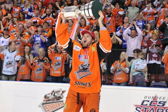 Champion Spirit: Levi Nelson holds aloft the Elite League play-off trophy after his goal finally edged out Cardiff Devils in an epic final in Nottingham.Picture: dean woolley
