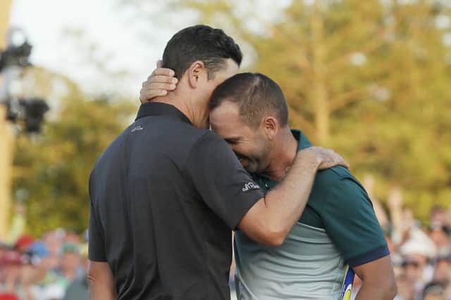 Sergio Garcia embraces Justin Rose after making his birdie putt on the 18th green to win the Masters in Augusta. Picture: AP Photo/David J. Phillip.