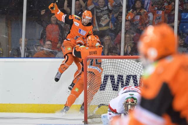 GAME WINNER: Levi Nelson jumps for joy with Sheffield Steelers team-mate Rob Dowd close by after scoring a dramatic overtime winner against Cardiff devils. Picture: Dean Woolley.