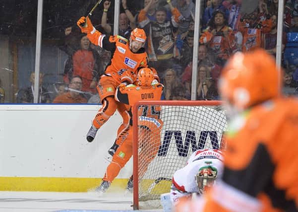 GAME WINNER: Levi Nelson jumps for joy with Sheffield Steelers team-mate Rob Dowd close by after scoring a dramatic overtime winner against Cardiff devils. Picture: Dean Woolley.