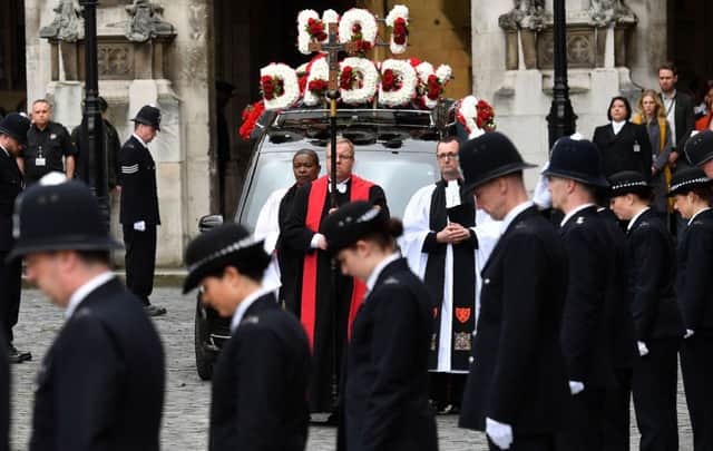 The hearse carrying the coffin of Pc Keith Palmer leaves Westminster's Chapel of St Mary Undercroft in London on its way to Southwark Cathedral