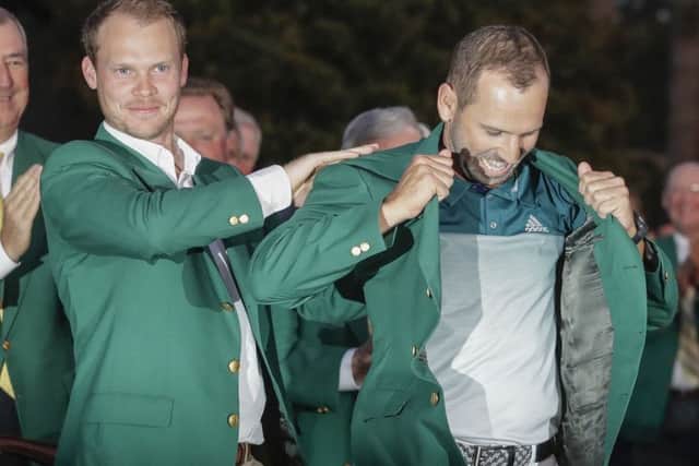 Danny Willett of England, puts a green jacket on Sergio Garcia, of Spain, after the Masters golf tournament, Sunday, April 9, 2017, in Augusta, Ga. (AP Photo/Chris Carlson)