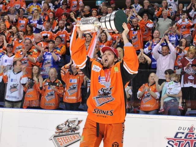 Levi Nelson raises the trophy above his head after Sheffield Steelers beat Cardiff Devils to win the Elite League play-off title (Picture: Dean Woolley).