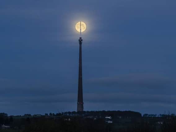 April's full moon, also known as a 'Pink Moon', is seen near Emley Moor transmitting station on Emley Moor in Kirklees.