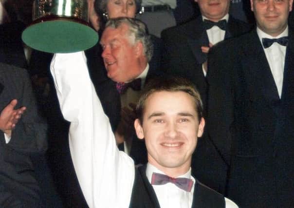 Dominant: Stephen Hendry raises the trophy after his seventh world title success. (Picture: PA)