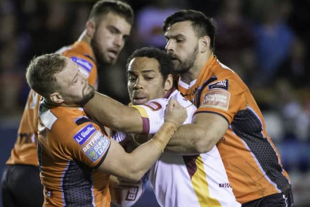 Huddersfield's Leroy Cudjoe is tackled by Castleford's Paul McShane and Matt Cook. (SWPix.com)