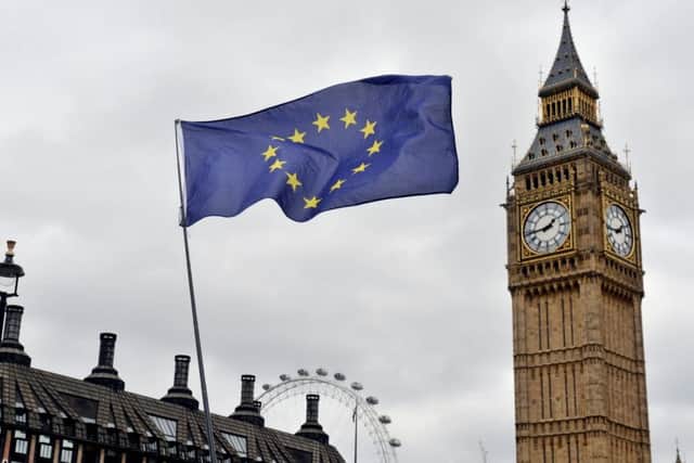 An EU flag flies in front of the Houses of Parliament in Westminster, London Photo: Victoria Jones/PA Wire