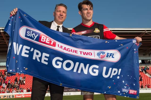 Doncaster Rovers manager Darren Ferguson celebrates promotion with John Marquis after the Sky Bet League Two match at the Keepmoat Stadium, Doncaster. (Picture: PA)
