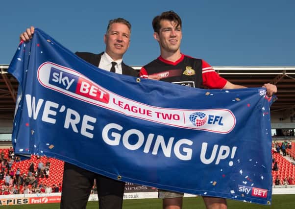 Doncaster Rovers manager Darren Ferguson celebrates promotion with John Marquis after the Sky Bet League Two match at the Keepmoat Stadium, Doncaster. (Picture: PA)