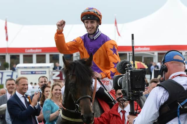 Harbour Law ridden by George Baker celebrates after winning the Ladbrokes St Leger Stakes during day four of the 2016 Ladbrokes St Leger Festival at Doncaster Racecourse (Picture:: Anna Gowthorpe/PA Wire)