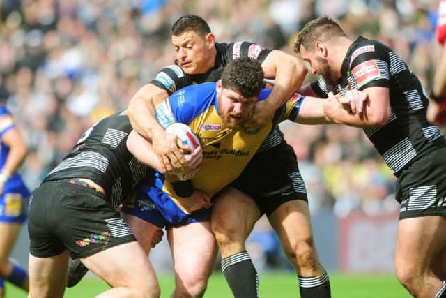 Leeds Rhinos' Mitch Garbutt charges at the Hull defence.
 Picture: Tony Johnson.