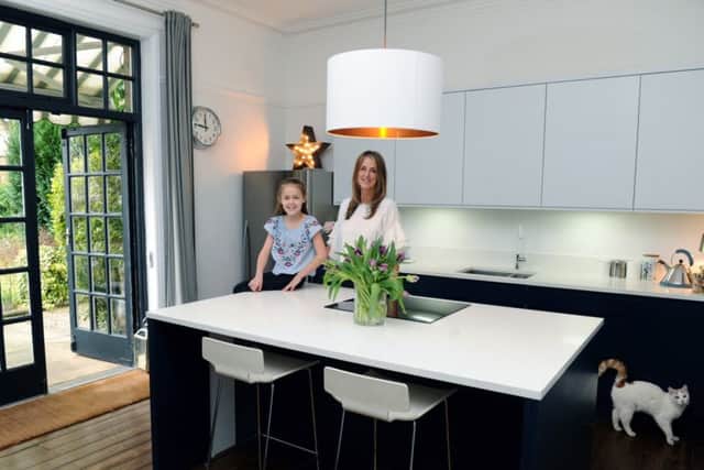Louise and Ruby in the kitchen with cabinets from Linda Barker's range for Wren