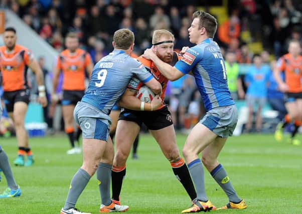 STOP RIGHT THERE: Castleford Tigers' Oliver Holmes finds his path forward blocked by Wakefield Trinity. Picture: Scott Merrylees