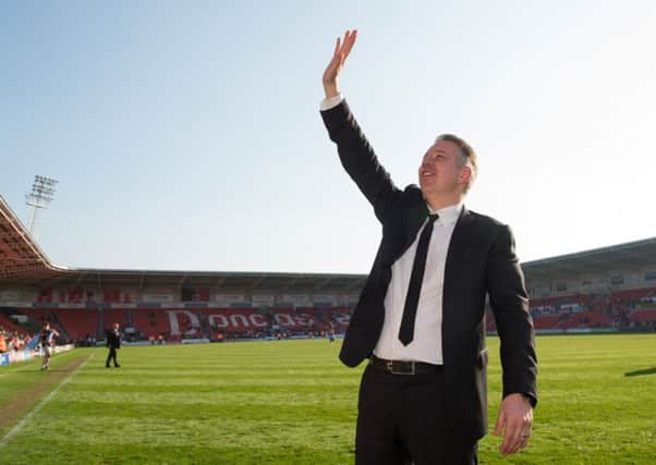 Doncaster Rovers manager Darren Ferguson applauds the fans after his side clinched a swift return to League One with victory over Mansfield Town at the Keepmoat Stadium (Picture: John Buckle/PA).