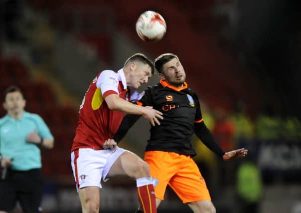 Rotherham United's Richie Smallwood pictured duelling with Sheffield Wednesday's Gary Hooper (Picture: Steve Ellis).