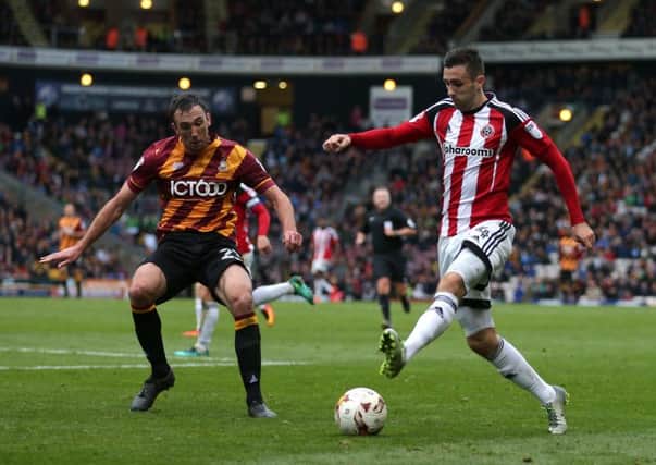 WE MEET AGAIN: Sheffield United's Danny Lafferty, right, and Bradford City's Rory McArdle battle for possession during the 3-3 draw between the two clubs at Valley Parade last October. Picture: Simon Bellis/Sportimage