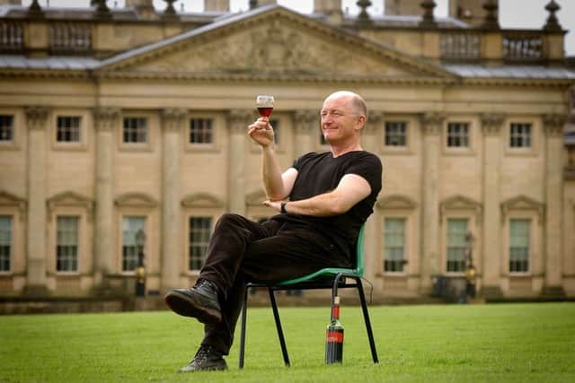 TV wine expert Oz Clarke tries a glass of red wine in front of Harewood House, as part of the Harewood Food and Drink Festival in 2003.