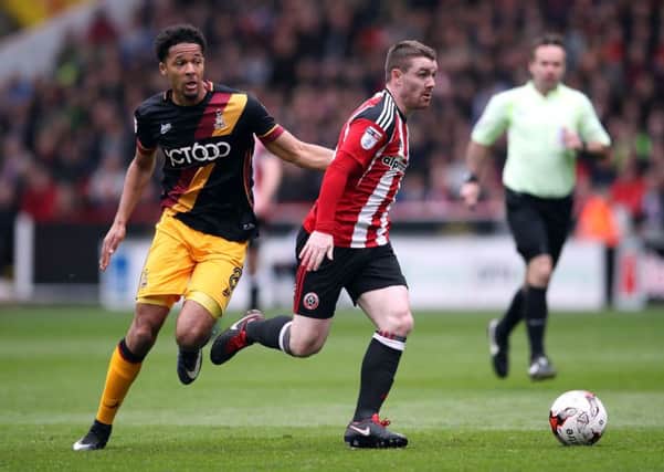 Sheffield United's John Fleck (right) and Bradford City's Timothee Dieng battle for the ball. Picture: Nick Potts/PA