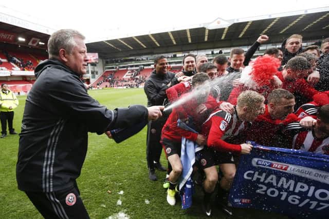 Chris Wilder manager of Sheffield Utd sprays champagne over his players during the English League One match at Bramall Lane Stadium, Sheffield. (Picture: Simon Bellis/Sportimage)