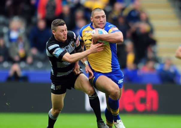 GET OFF: Leeds Rhinos' Ryan Hall shrugs of Hull FC Jamie Shaul
 in the recent Yorkshire derby. Picture: Tony Johnson.