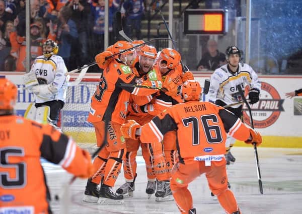 MAGIC MOMENT: Guillaume Desbiens is mobbed by his Sheffield Steelers' team-mates after scoring a dramatic overtime winner against Nottingham in the EIHL play-off quarter-finals last month. Picture: Dean Woolley.