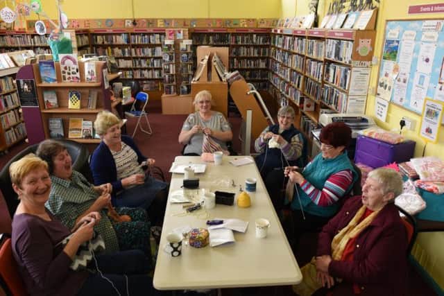 The knitting group who meets at the library and community centre