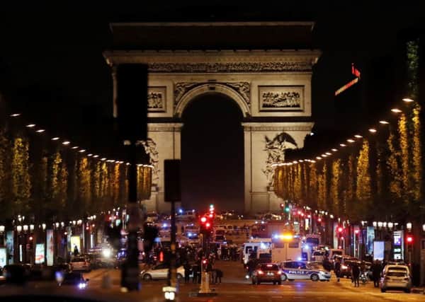 Police officers block the access to the Champs Elysees in Paris after the shooting .Photo: THOMAS SAMSON/AFP/Getty Images.