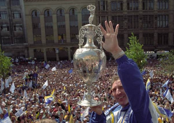 Champions: Leeds United manager Howard Wilkinson holds aloft the championship trophy in front of thousands of adoring fans in May, 1992. Picture: YPN