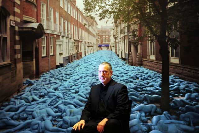 Artist Spencer Tunick pictured with one of his photographs,Sea of Hull. Picture: Simon Hulme