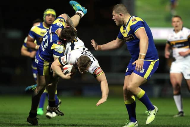 Leeds Rhinos' Sam Hallas is tackled by Doncaster's Ryan Wright (Picture: Bruce Rollinson).