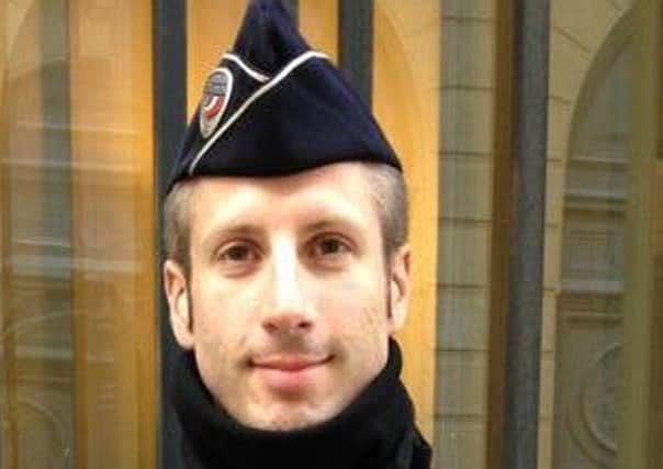 This undated image provided on Friday, April 21, 2017, by FLAG, an association of LGBT police officers, shows French police officer Xavier Jugele. The policeman killed on Paris' most famous boulevard was identified as Xavier Jugele by Flag! Its president, Mickael Bucheron, told AP the dead officer would have celebrated his 38th birthday at the beginning of May. (FLAG via AP)