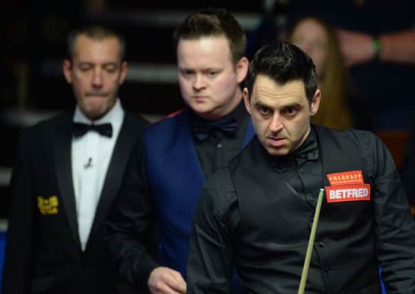 Ronnie O'Sullivan studies the table in his match against Shaun Murphy. Picture: Anna Gowthorpe/PA.