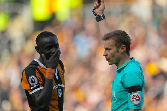 Hull City's Oumar Niasse is shown the yellow card by referee Mike Jones. Picture: Richard Sellers/PA