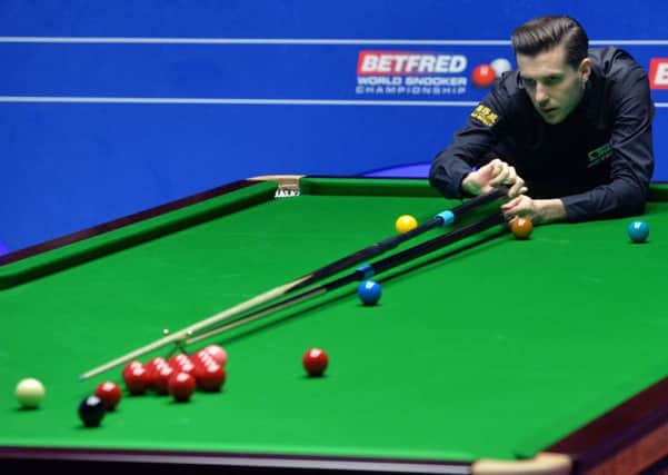 Defending champion Mark Selby returns to action today needing three frames for victory (Picture: Anna Gowthorpe/PA).