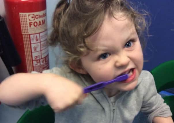 A Sheffield youngster practices brushing her teeth.