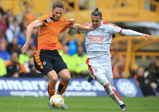 Wolverhampton Wanderers' James Henry (left) and Huddersfield Town's Jason Davidson battle for the ball during the Sky Bet Championship match at Molineux, on Saturday October 3, 2015 (Picture: PA)