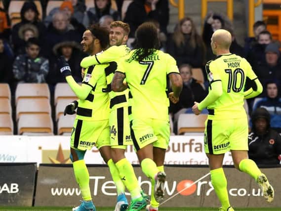 The Huddersfield Town squad celebrate Izzy Brown's winning goal against Wolves