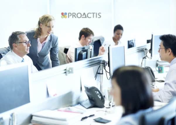 A group of office workers at PROACTIS.
