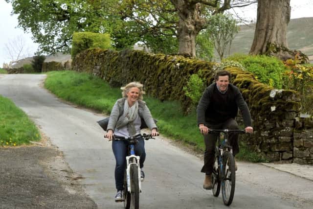 Jonny Caygill and his wife Sophie on their bikes in the village.