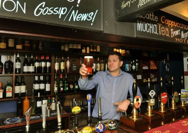 Chris Gregson behind the bar of The Fountaine Inn at Linton in Wharfedale.