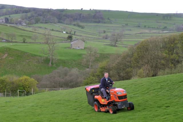 Tony Foster cuts the grass around the holiday park.