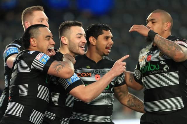 Hull FC's Jake Connor, centre, celebrates scoring his team's first try.