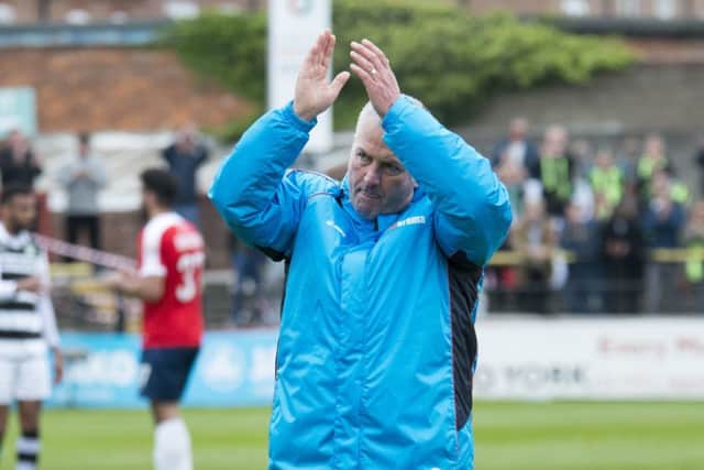 York manager Gary Mills applauds the fans at the final whistle.