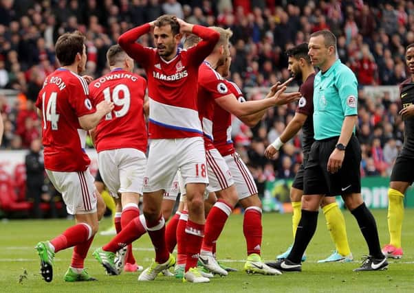 Tough call: Middlesbroughs Cristhian Stuani (centre) reacts after Manchester City are awarded a penalty by referee Kevin Friend.