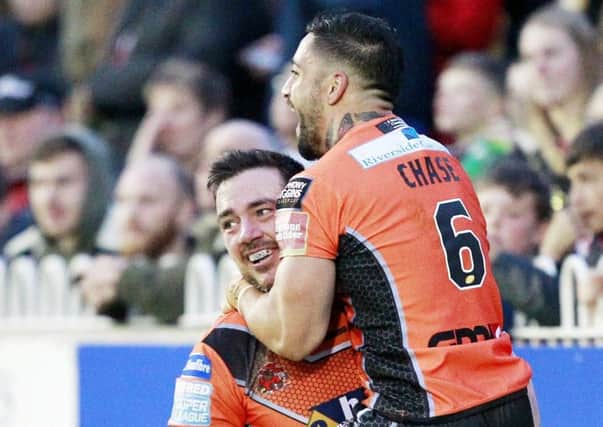 Castleford's try scorer Grant Millington congratulated by Rangi Chase
