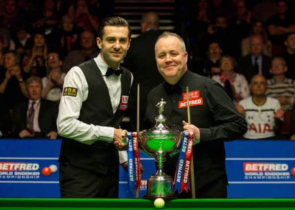 Mark Selby and John Higgins shakes hands at the start of the final.