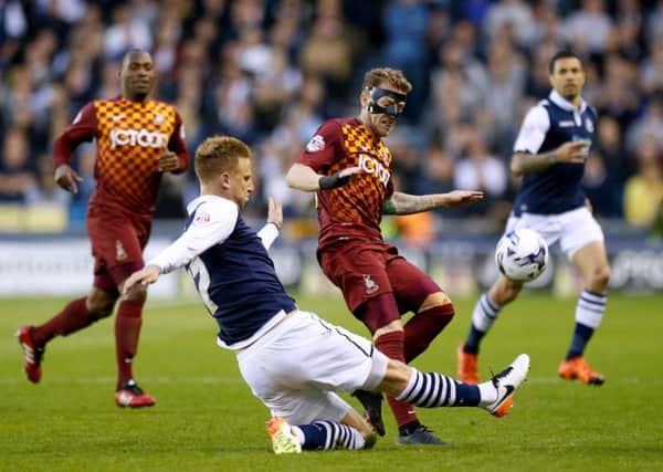 Millwall's Byron Webster, second left, and Bradford City's Billy Clarke, centre, battle for the ball (Picture: Steven Paston/PA Wire).