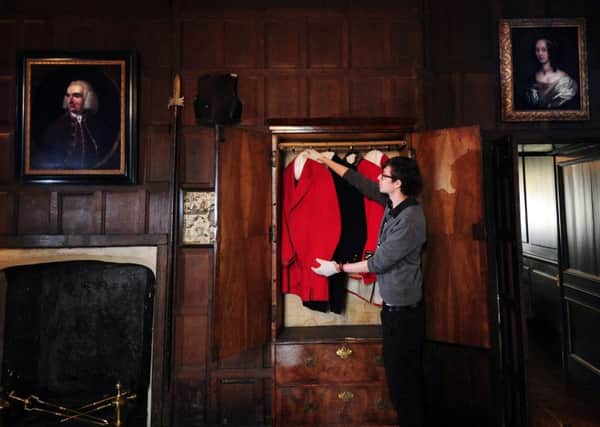 OPEN DOORS: Guy Newton opens the Walnut Wardrobe showing Hunting Pinks which belonged to industrialist Frank Green. PIC: Simon Hulme