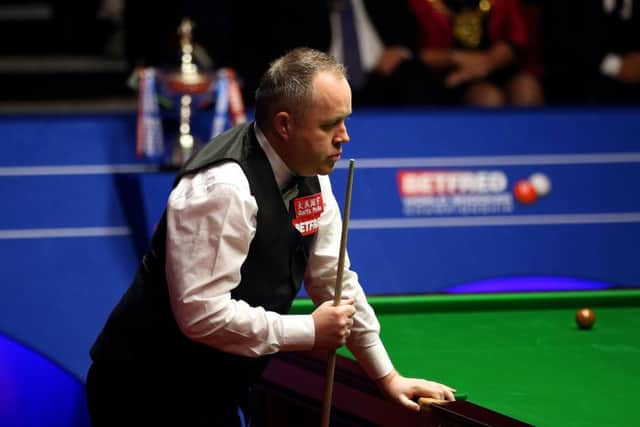 John Higgins shows his disappointment at a missed shot against Mark Selby. Picture: Steven Paston/PA