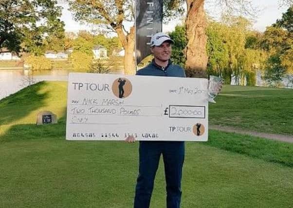Huddersfield's Nick Marsh with his winner's cheque at The Mere.